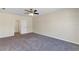 A cozy bedroom featuring carpeted floors, a ceiling fan, and access to other rooms in the home at 39 Hickory Course Way, Ocala, FL 34472