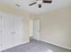 This bedroom includes carpeted floor, ceiling fan, and a spacious closet with double doors at 39 Hickory Course Way, Ocala, FL 34472