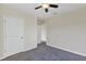 Carpeted bedroom featuring a ceiling fan and closet access at 39 Hickory Course Way, Ocala, FL 34472