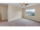 Bedroom with neutral walls, carpeted floor, ceiling fan, and window at 39 Hickory Course Way, Ocala, FL 34472