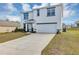 Inviting two-story home with a long driveway, attached garage, and manicured front yard at 39 Hickory Course Way, Ocala, FL 34472