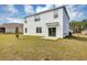 Exterior of the home featuring a sliding glass door and spacious yard at 39 Hickory Course Way, Ocala, FL 34472