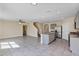 Open floor plan showcases the kitchen with island, stainless steel appliances, and staircase access at 39 Hickory Course Way, Ocala, FL 34472