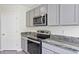 Well-equipped kitchen features stainless steel appliances, granite countertops, and ample cabinet space at 39 Hickory Course Way, Ocala, FL 34472