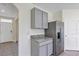 View of kitchen area with stainless steel appliances and granite countertop, adjacent to entryway at 39 Hickory Course Way, Ocala, FL 34472