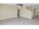 Spacious living room featuring tile floors, a ceiling fan, and access to the kitchen at 39 Hickory Course Way, Ocala, FL 34472