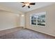 Inviting living room featuring tile floors, a ceiling fan, and a bright window at 39 Hickory Course Way, Ocala, FL 34472