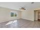 Bright living room showcasing tile floors, natural light, and views of the backyard at 39 Hickory Course Way, Ocala, FL 34472