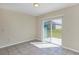 Living area with tile flooring and sliding glass doors that provide access to the backyard at 39 Hickory Course Way, Ocala, FL 34472