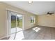 Bright living space with sliding glass doors and large window, complemented by neutral walls and tile floors at 39 Hickory Course Way, Ocala, FL 34472