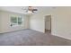 Spacious main bedroom with neutral tones, carpeted floors, ceiling fan, and en-suite bathroom access at 39 Hickory Course Way, Ocala, FL 34472