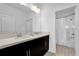 Bright bathroom featuring a double vanity with a quartz countertop and a shower with tub at 394 Captiva Dr, Davenport, FL 33896