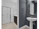 Stylish bathroom with a glass-enclosed shower, modern sink, and a gray accent wall at 394 Captiva Dr, Davenport, FL 33896