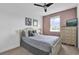Cozy bedroom with neutral tones, featuring a comfortable bed, a window, and a ceiling fan at 394 Captiva Dr, Davenport, FL 33896