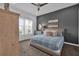 Comfortable bedroom with calming gray accent wall and a large window for natural light at 394 Captiva Dr, Davenport, FL 33896