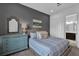 Stylish bedroom featuring a serene gray accent wall, elegant decor, and lots of natural light at 394 Captiva Dr, Davenport, FL 33896