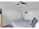 Bright bedroom features a ceiling fan, a double closet, and a comfortable bed at 394 Captiva Dr, Davenport, FL 33896