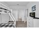 Bright bedroom featuring a bunk bed with a monochromatic design, white dresser, and ensuite bathroom at 394 Captiva Dr, Davenport, FL 33896