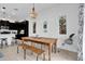 Dining area adjacent to kitchen, featuring a farmhouse table and stylish decor at 394 Captiva Dr, Davenport, FL 33896