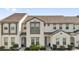 Two-story townhome featuring well-kept landscaping and a modern architectural style at 394 Captiva Dr, Davenport, FL 33896
