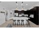 Modern kitchen with dark cabinets, white countertops, and stainless steel appliances at 394 Captiva Dr, Davenport, FL 33896