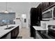 Modern kitchen with a large island, dark cabinets, and updated appliances at 394 Captiva Dr, Davenport, FL 33896