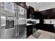 Contemporary kitchen showcasing stainless steel refrigerator and sleek dark cabinetry at 394 Captiva Dr, Davenport, FL 33896