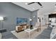 Cozy living room with stylish furniture, a flat-screen TV, and modern accents at 394 Captiva Dr, Davenport, FL 33896