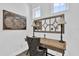 Stylish home office with a wooden desk, decorative mirror, and comfortable seating at 394 Captiva Dr, Davenport, FL 33896