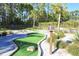 Enjoy a round of mini-golf on the community's putting green surrounded by tropical trees at 394 Captiva Dr, Davenport, FL 33896