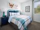 Comfortable bedroom with bright accents, including a turquoise bed frame and unique animal-themed wall art at 4969 Kaia Ave, Winter Haven, FL 33884
