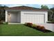 Charming single-story home featuring a two-car garage and a well-manicured front yard with colorful flower beds at 4969 Kaia Ave, Winter Haven, FL 33884