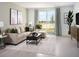 Inviting living room with a comfortable sectional sofa, stylish coffee table, and large windows with natural light at 4969 Kaia Ave, Winter Haven, FL 33884