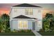 Two-story home showcasing a neutral color palette, well-maintained landscaping, and welcoming entrance at 5063 Starling Bird Ln, St Cloud, FL 34771
