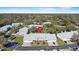 Community aerial view highlighting residential buildings, tennis court, mature landscaping, and ample parking at 5273 Tunbridge Wells Ln # 1601, Orlando, FL 32812