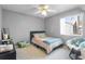 Neutral bedroom featuring a comfortable bed with a teal throw blanket and a cozy papasan chair at 5273 Tunbridge Wells Ln # 1601, Orlando, FL 32812