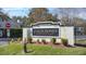 Community entrance sign for Coach Homes at Dover Village surrounded by manicured landscaping at 5273 Tunbridge Wells Ln # 1601, Orlando, FL 32812