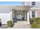 Inviting front entrance with a charming floral wreath, bench, and covered porch at 5273 Tunbridge Wells Ln # 1601, Orlando, FL 32812