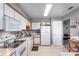 Functional kitchen with white cabinetry, essential appliances, and convenient access to other rooms at 5273 Tunbridge Wells Ln # 1601, Orlando, FL 32812