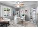 Bright office space featuring a ceiling fan, desk, map decal, and a comfortable chair near the window at 5273 Tunbridge Wells Ln # 1601, Orlando, FL 32812