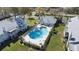 Aerial view of community pool area with lounge chairs and landscaped surroundings at 5273 Tunbridge Wells Ln # 1601, Orlando, FL 32812