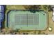 Aerial view of the community tennis court surrounded by manicured landscaping and fencing at 5273 Tunbridge Wells Ln # 1601, Orlando, FL 32812