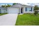 Charming single-Gathering home featuring a two-car garage, well-manicured lawn, and inviting curb appeal at 601 Dominish Estates Dr, Apopka, FL 32712