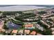 Community aerial view, highlighting the lake, clubhouse, pool, and residential area in a scenic landscape at 612 Via Isabelle Dr, Debary, FL 32713