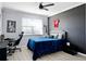 This bedroom features stylish decor, including modern furniture and a unique accent wall, creating a cozy space at 612 Via Isabelle Dr, Debary, FL 32713
