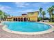 Large community pool surrounded by lush landscaping and comfortable lounge chairs, perfect for relaxation at 612 Via Isabelle Dr, Debary, FL 32713