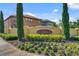 A welcome sign amidst manicured landscaping and tall cypress trees marks the entrance to the Riviera Bella community at 612 Via Isabelle Dr, Debary, FL 32713