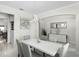 Elegant dining area with a white table, gray chairs, and a modern light fixture above at 612 Via Isabelle Dr, Debary, FL 32713