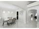 Bright dining room featuring modern chandelier, white tile floor, and views into the home at 612 Via Isabelle Dr, Debary, FL 32713