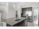 Beautiful kitchen with stainless steel appliances, dark cabinets, granite island, and barstool seating at 612 Via Isabelle Dr, Debary, FL 32713